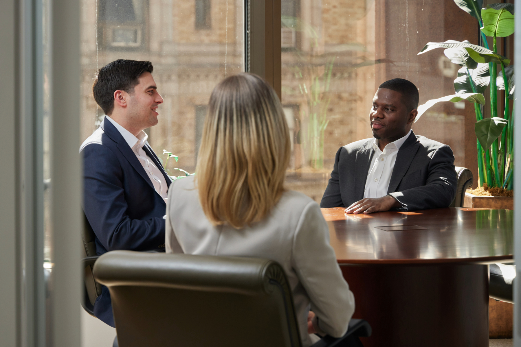candid photo of 1919 employees at a conference table